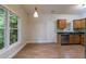Bright dining area with views of the trees outside of the large window with nearby kitchen at 3135 Washington Rd, Atlanta, GA 30344