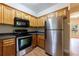 Modern kitchen with stainless steel appliances, dark countertops, and wood cabinets at 3135 Washington Rd, Atlanta, GA 30344