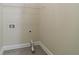 The laundry closet features white walls, shelving, gray flooring, and hookups for a washer and dryer at 3135 Washington Rd, Atlanta, GA 30344