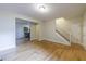 Bright living room with hardwood floors leading to the staircase and kitchen area at 3135 Washington Rd, Atlanta, GA 30344