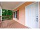 Inviting porch with wood flooring, and a white front door at 3135 Washington Rd, Atlanta, GA 30344