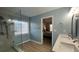 Modern bathroom with glass shower, dual sinks, and stylish fixtures leading to an adjacent bedroom at 4424 High Gate Nw Dr, Acworth, GA 30101