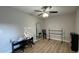 Bedroom with wood floors, ceiling fan, piano, ballet bar, and decorative mirror at 4424 High Gate Nw Dr, Acworth, GA 30101