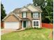 Charming two-story brick home with green shutters, lush lawn, and a two-car garage at 4424 High Gate Nw Dr, Acworth, GA 30101