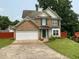 Charming two-story brick home with green shutters, lush lawn, and a two-car garage at 4424 High Gate Nw Dr, Acworth, GA 30101