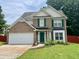 Charming two-story home with brick facade, green shutters, landscaped yard, and a two-car garage at 4424 High Gate Nw Dr, Acworth, GA 30101