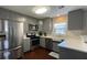 Well-lit kitchen with stainless steel appliances, gray cabinets, and bright white countertops at 4424 High Gate Nw Dr, Acworth, GA 30101