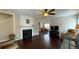 Cozy living room features a fireplace, hardwood floors, and an open archway at 4424 High Gate Nw Dr, Acworth, GA 30101