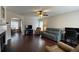 Spacious living room boasts hardwood floors, a ceiling fan, and an archway to the dining area at 4424 High Gate Nw Dr, Acworth, GA 30101