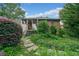 Back of house with a lush garden, stone walkway, and convenient step access at 451 S Columbia Dr, Decatur, GA 30030