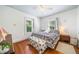 Bedroom with wood floors, natural light from windows, and bench seat at foot of the bed at 451 S Columbia Dr, Decatur, GA 30030