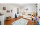 Bright bedroom with hardwood floors and built-in shelves showcasing toys and books at 451 S Columbia Dr, Decatur, GA 30030