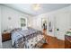 Bedroom with wood floors, natural light from windows, and bench seat at foot of the bed at 451 S Columbia Dr, Decatur, GA 30030
