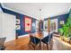 Charming dining room features hardwood floors, blue walls, and natural light from the large window at 451 S Columbia Dr, Decatur, GA 30030