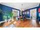 Charming dining room features hardwood floors, blue walls, and natural light from the large window at 451 S Columbia Dr, Decatur, GA 30030