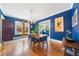 Charming dining room features hardwood floors, blue walls, and natural light from the large window at 451 S Columbia Dr, Decatur, GA 30030