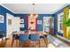 Charming dining room features hardwood floors, blue walls, and natural light from the large window at 451 S Columbia Dr, Decatur, GA 30030