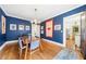 Charming dining room features hardwood floors, blue walls, and natural light from the large window at 451 S Columbia Dr, Decatur, GA 30030