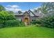 Charming brick Tudor-style home featuring a well-manicured lawn and lush greenery in a desirable neighborhood at 451 S Columbia Dr, Decatur, GA 30030