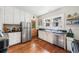 Classic kitchen featuring white cabinets, stainless steel appliances, and hardwood flooring at 451 S Columbia Dr, Decatur, GA 30030