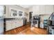 Traditional kitchen with white cabinets, stainless steel appliances, and hardwood floors with natural light at 451 S Columbia Dr, Decatur, GA 30030