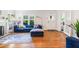 Sunlit living room boasts hardwood floors, fireplace, and a cozy blue sectional sofa at 451 S Columbia Dr, Decatur, GA 30030