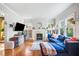 Bright living room with hardwood floors, fireplace, built-ins and a comfortable blue sofa at 451 S Columbia Dr, Decatur, GA 30030