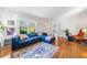 Spacious living room featuring hardwood floors, a comfortable blue sectional, and bright natural light at 451 S Columbia Dr, Decatur, GA 30030