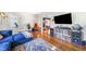 Open-concept living room with hardwood floors, a cozy blue sectional, and seamless flow to dining area at 451 S Columbia Dr, Decatur, GA 30030