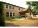 Backyard view showcasing the house, patio, landscaped yard, and established trees at 560 Tuscany Walk Ln, Lawrenceville, GA 30043
