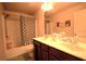 Functional bathroom featuring a tub, shower, toilet, and a dark wood double vanity at 560 Tuscany Walk Ln, Lawrenceville, GA 30043