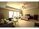 Spacious bedroom with ceiling fan, large windows, a couch and bed with patterned blanket at 560 Tuscany Walk Ln, Lawrenceville, GA 30043