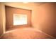Empty bedroom with large window, offering plenty of natural light and neutral carpet at 560 Tuscany Walk Ln, Lawrenceville, GA 30043