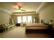 Bright bedroom featuring neutral walls, ceiling fan, and windows for ample natural light at 560 Tuscany Walk Ln, Lawrenceville, GA 30043