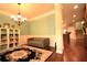 Dining room with hardwood floors, a cozy gray sofa, and an adjacent staircase at 560 Tuscany Walk Ln, Lawrenceville, GA 30043
