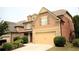 Beautiful two-story home featuring a two-car garage, brick and siding exterior, and landscaped yard at 560 Tuscany Walk Ln, Lawrenceville, GA 30043