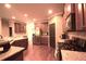 Kitchen features stainless steel appliances, granite countertops and wood floors at 560 Tuscany Walk Ln, Lawrenceville, GA 30043