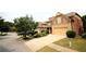 Neighborhood street view showcasing a two-story house with a two-car garage and landscaped yard at 560 Tuscany Walk Ln, Lawrenceville, GA 30043