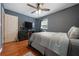 Bedroom featuring hardwood floors, a ceiling fan, and a dresser at 57 Jonathan Rd, Riverdale, GA 30274