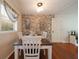 Dining room with brick accent wall, hardwood floors, and natural light at 57 Jonathan Rd, Riverdale, GA 30274