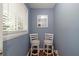 Hallway nook with hardwood floors, a window, and two chairs at 57 Jonathan Rd, Riverdale, GA 30274