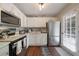 Bright kitchen with white cabinets, stainless steel appliances, and hardwood floors at 57 Jonathan Rd, Riverdale, GA 30274