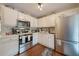 Modern kitchen with stainless steel appliances, crisp white cabinets, and hardwood floors at 57 Jonathan Rd, Riverdale, GA 30274