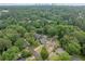 An aerial view showcases the property nestled amongst lush greenery, with the city skyline in the distance at 2123 Drew Valley Ne Rd, Brookhaven, GA 30319