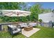 Relaxing outdoor space with comfortable seating, an umbrella for shade, and a built-in grill for easy entertaining at 2123 Drew Valley Ne Rd, Brookhaven, GA 30319