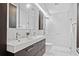 Contemporary bathroom with double sinks, sleek vanity, and a glass-enclosed walk-in shower with marble tiling at 2123 Drew Valley Ne Rd, Brookhaven, GA 30319