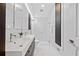 Modern bathroom with double sinks, sleek vanity, and a glass-enclosed walk-in shower with marble tiling at 2123 Drew Valley Ne Rd, Brookhaven, GA 30319