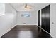 Clean bedroom with built-in wardrobe, ceiling fan, and dark wood floors at 2123 Drew Valley Ne Rd, Brookhaven, GA 30319