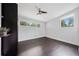 Bright, sparsely furnished bedroom features a ceiling fan and dark wood floors at 2123 Drew Valley Ne Rd, Brookhaven, GA 30319