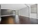 Spacious living room with dark hardwood floors, neutral walls, and ample natural light from the French doors at 2123 Drew Valley Ne Rd, Brookhaven, GA 30319